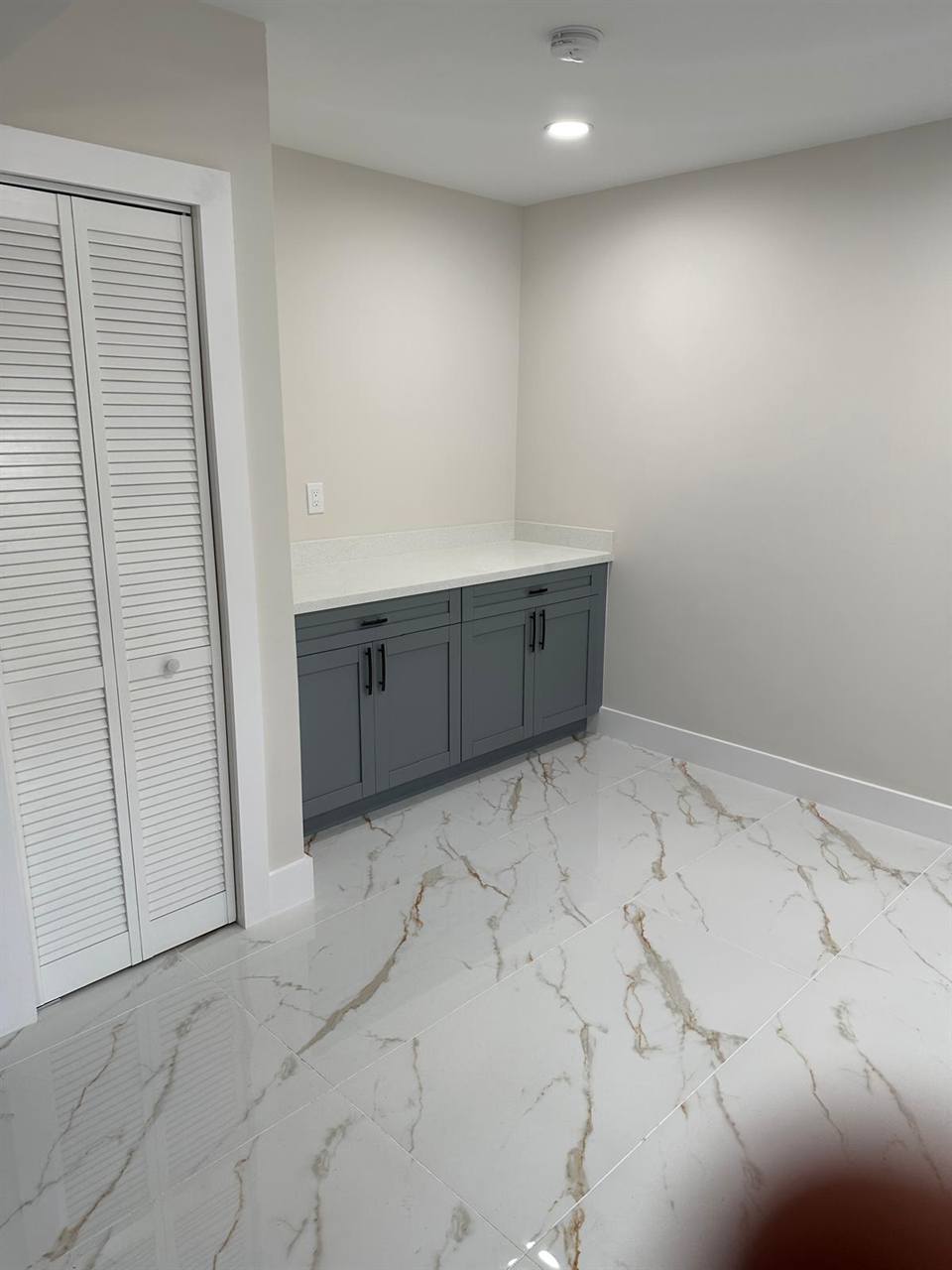 Marble flooring with gray cabinets