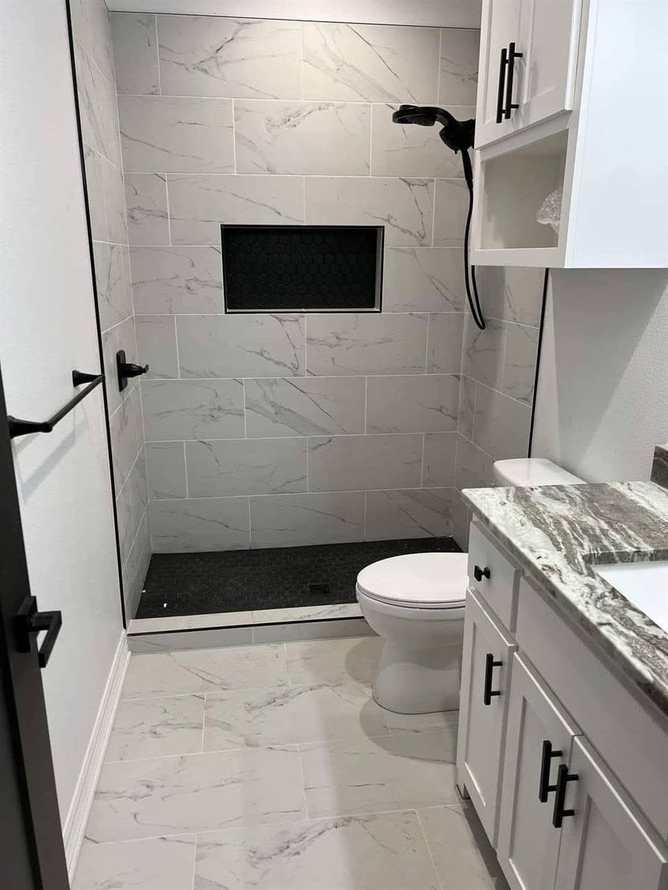 Bathroom white marble black fixtures shower niche