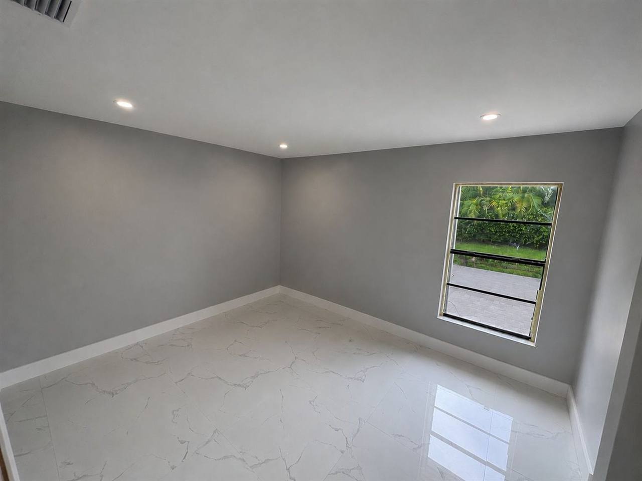 Room white marble flooring gray walls recessed lights