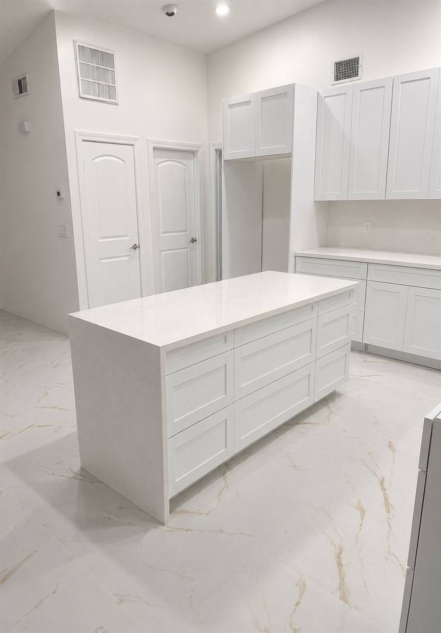 Kitchen island white shaker cabinets marble floor